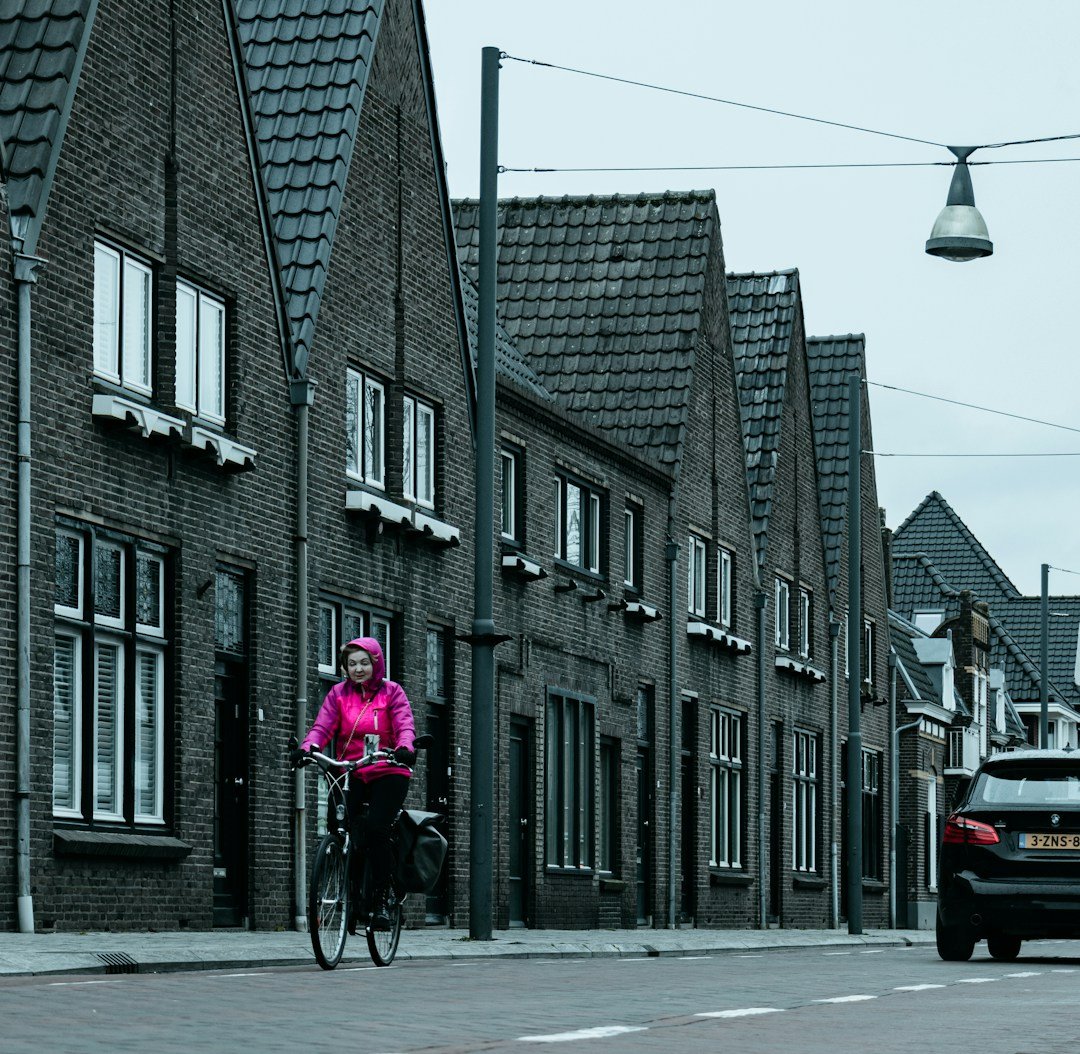 a person riding a bike down a street